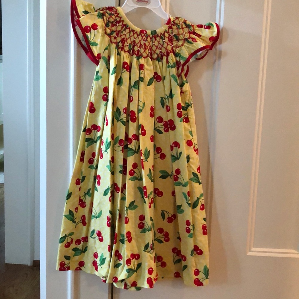 Beautiful girl’s cherry smocked dress